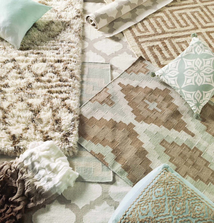 Close-up of rugs and pillows, featuring the Banks Ivory/Gray Trellis Wool Rug with an ivory and gray trellis pattern. Styleshot