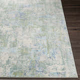 Close-up of the Riegelwood Area Rug showing its light beige, blue, and green contemporary design. Front