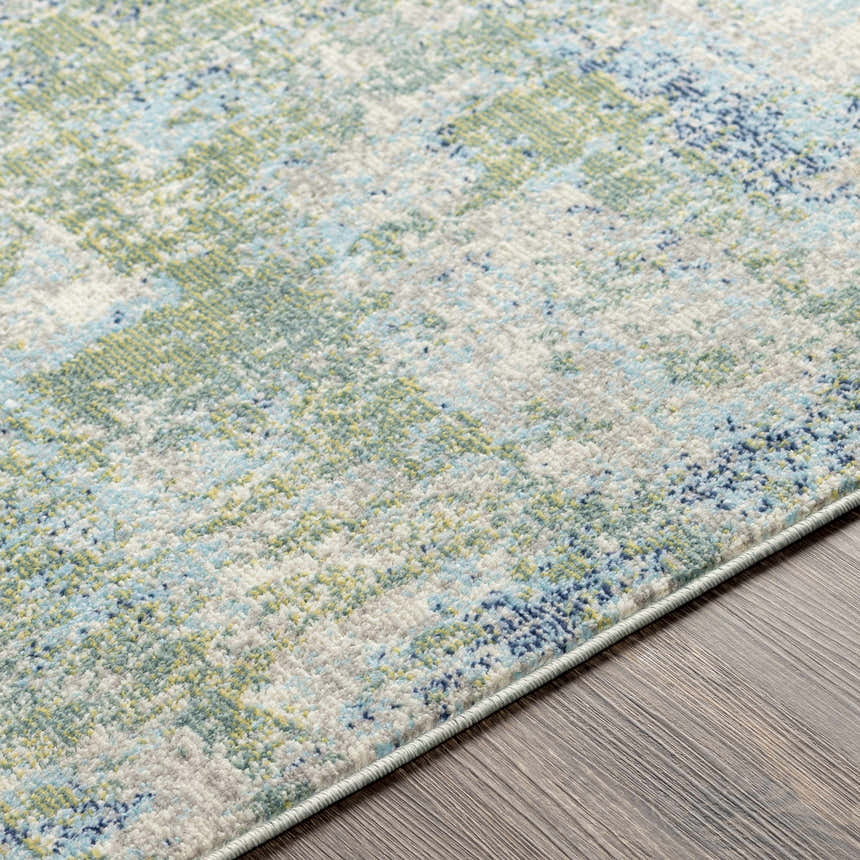 Close-up of the Riegelwood Area Rug. Features light beige, medium gray, green, navy, peach, and sky blue colors. Coastal style. Texture