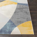 Close-up of Ringgold Area Rug with aqua, charcoal, light slate, mustard, peach, and taupe geometric design. Front