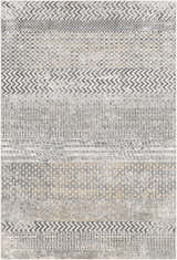Close-up of the Rombauer Area Rug showing charcoal, gray, and mustard geometric patterns and distressed texture. Design-Rectangle-5373