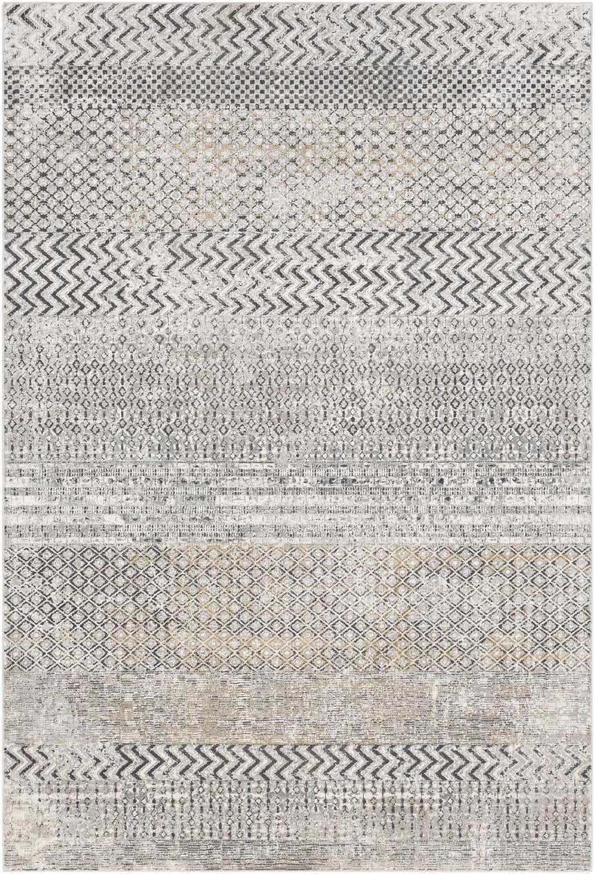 Close-up of the Rombauer Area Rug showing charcoal, gray, and mustard geometric patterns and distressed texture. Design-Rectangle-5373