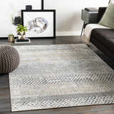 Living room scene with gray sofa and Rombauer Area Rug in charcoal, gray, light gray, and mustard. Roomscene-Rectangle