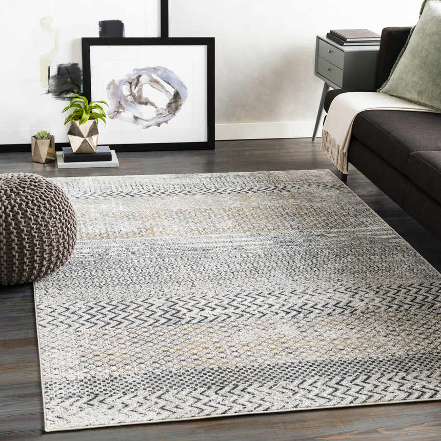 Living room scene with gray sofa and Rombauer Area Rug in charcoal, gray, light gray, and mustard. Roomscene-Rectangle