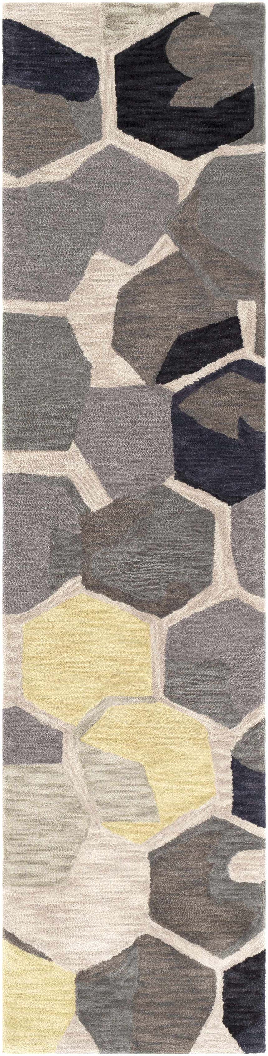 Close-up of the Romoland Area Rug; hand-tufted polyester with geometric shapes in black, brown, gray, and mustard tones. Design-Runner-28