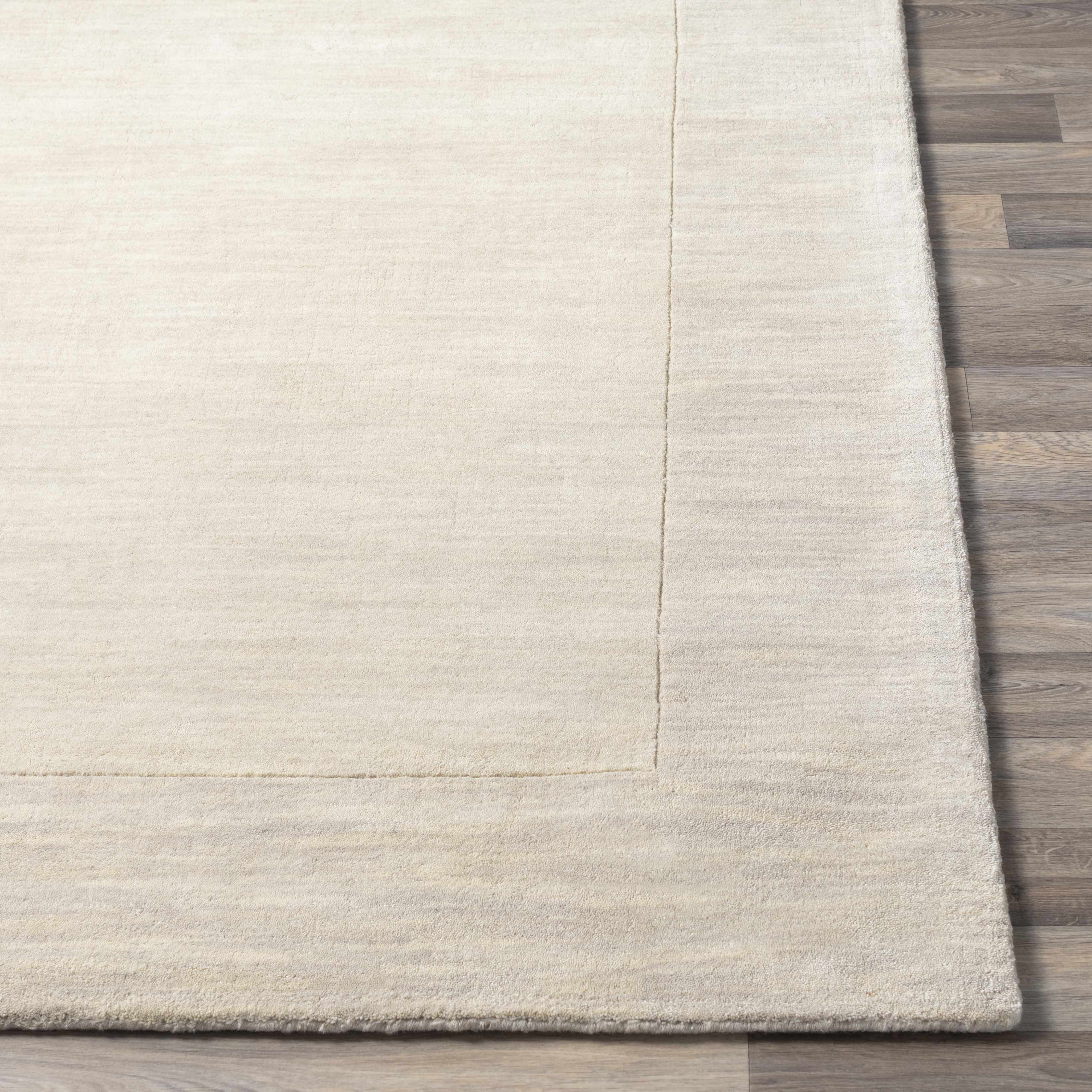 Straight-on shot of Bordered Solid Beige Cream Wool Rug, providing a full look at the design. Contemporary Area Rug Backing Canvas 