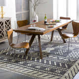 Dining room scene with a Rossville Area Rug, a black and white hand woven rug with a geometric design. Roomscene-Rectangle