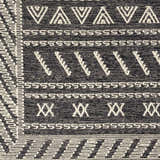 Close-up of the hand woven Rossville Area Rug. Black rug with geometric white patterns. Clearance item. Swatch