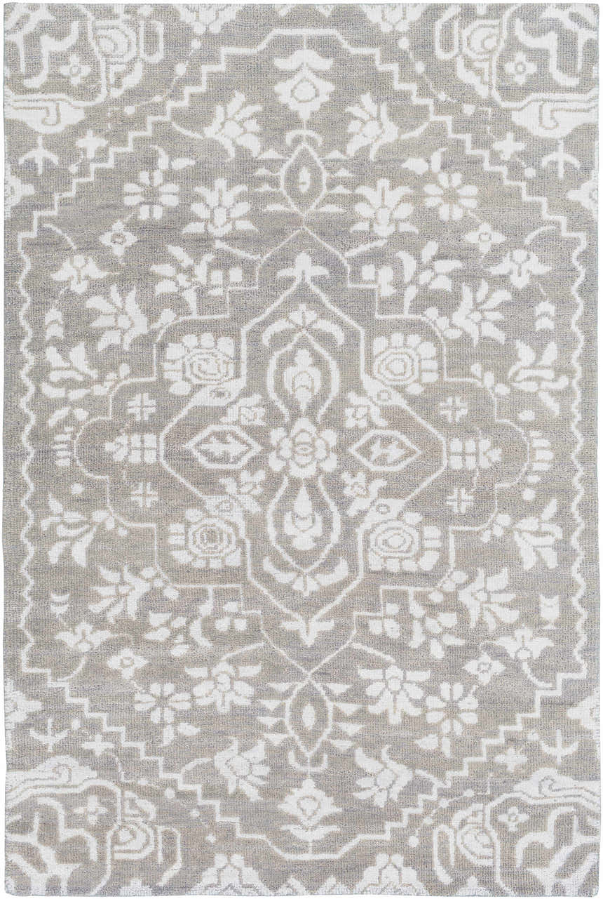 Close-up of Roxobel Clearance Rug. Light gray rug with a traditional white floral and geometric pattern. Hand-knotted texture. Design-Rectangle-69