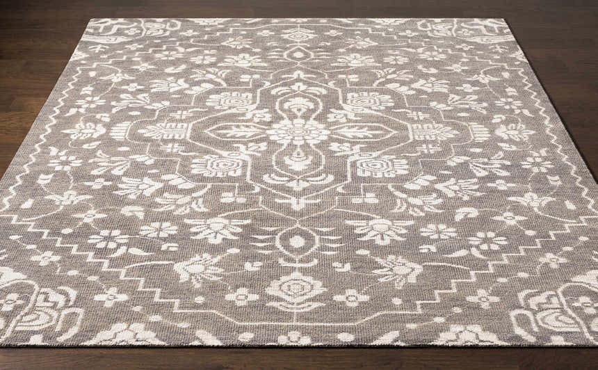 Close-up of Roxobel Clearance Rug. Light gray rug with medium gray floral and geometric traditional pattern. Hand-knotted texture. Front