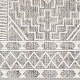 Close-up of the Reyn Area Rug, showcasing its geometric pattern in dark gray, light gray, and white tones. Swatch