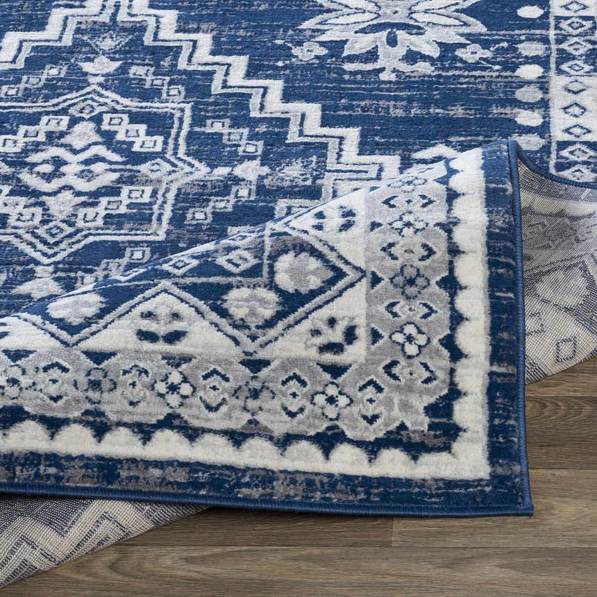 Close-up of the Ryton White&Blue Area Rug showing its bohemian geometric pattern and texture. Clearance rug. Fold