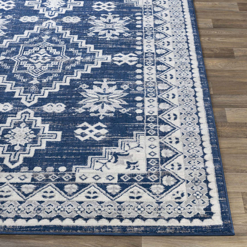 Close-up of the Ryton White&Blue Area Rug featuring a bohemian-inspired geometric pattern in shades of blue, gray, and white. Front