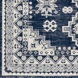 Close up of the Ryton White&Blue Area Rug showcasing its bohemian, geometric, and floral pattern in navy, white, and gray. Swatch