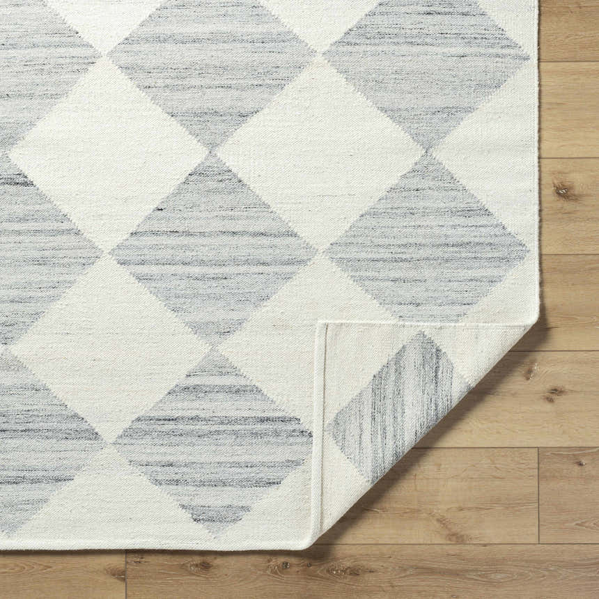 Close up of the Rakin Pearl Area Rug showing ivory and silver gray diamond pattern. Fold