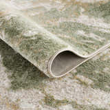 Close-up of the Lively Marble Green Area Rug showing its cream and green contemporary pattern and soft texture. Fold