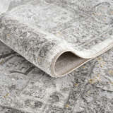 Close-up of the plush Liverpool Light Gray Area Rug showing its traditional pattern, soft texture, and bound edge. Fold