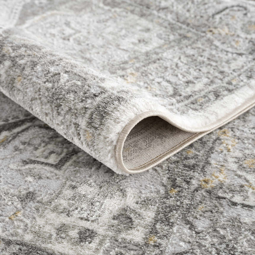 Close-up of the plush Liverpool Light Gray Area Rug showing its traditional pattern, soft texture, and bound edge. Fold