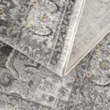 Close-up of the Liverpool Light Gray Area Rug showing its traditional pattern, gray tones, mustard accents, and woven texture. Fold