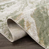 Close-up of the Lively Marble Green Area Rug showing its cream and green contemporary pattern and machine-woven texture. Fold