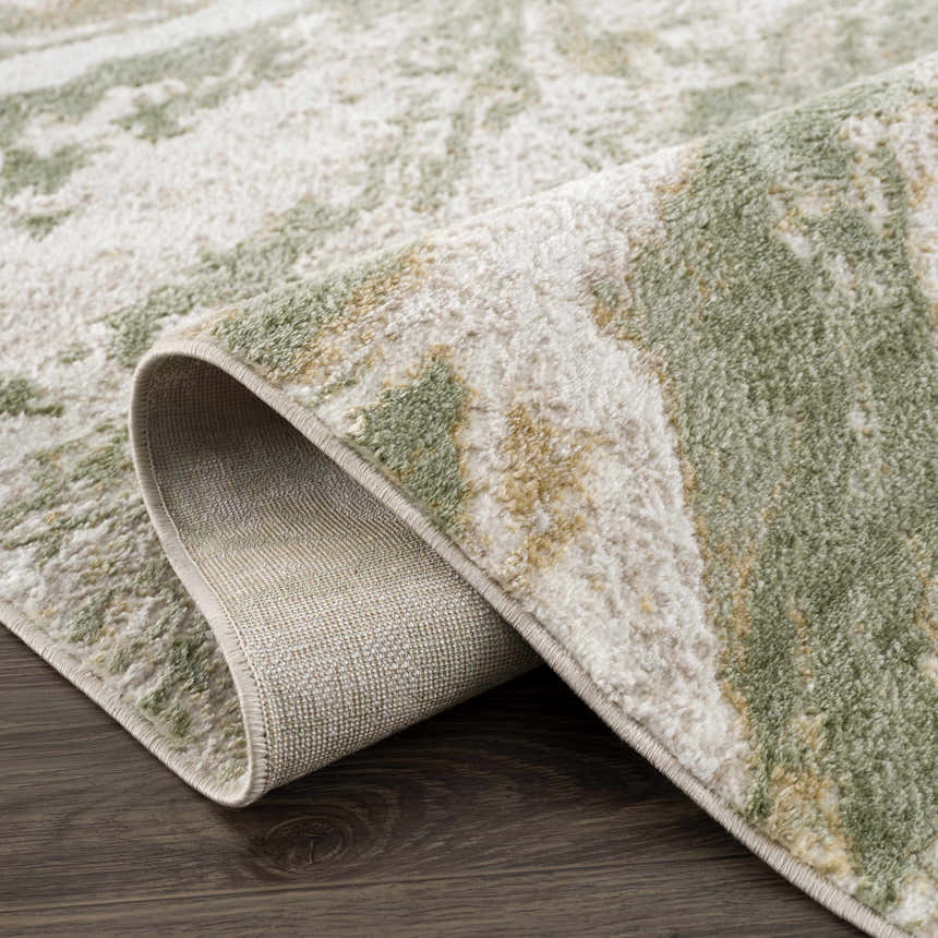 Close-up of the Lively Marble Green Area Rug showing its cream and green contemporary pattern and machine-woven texture. Fold