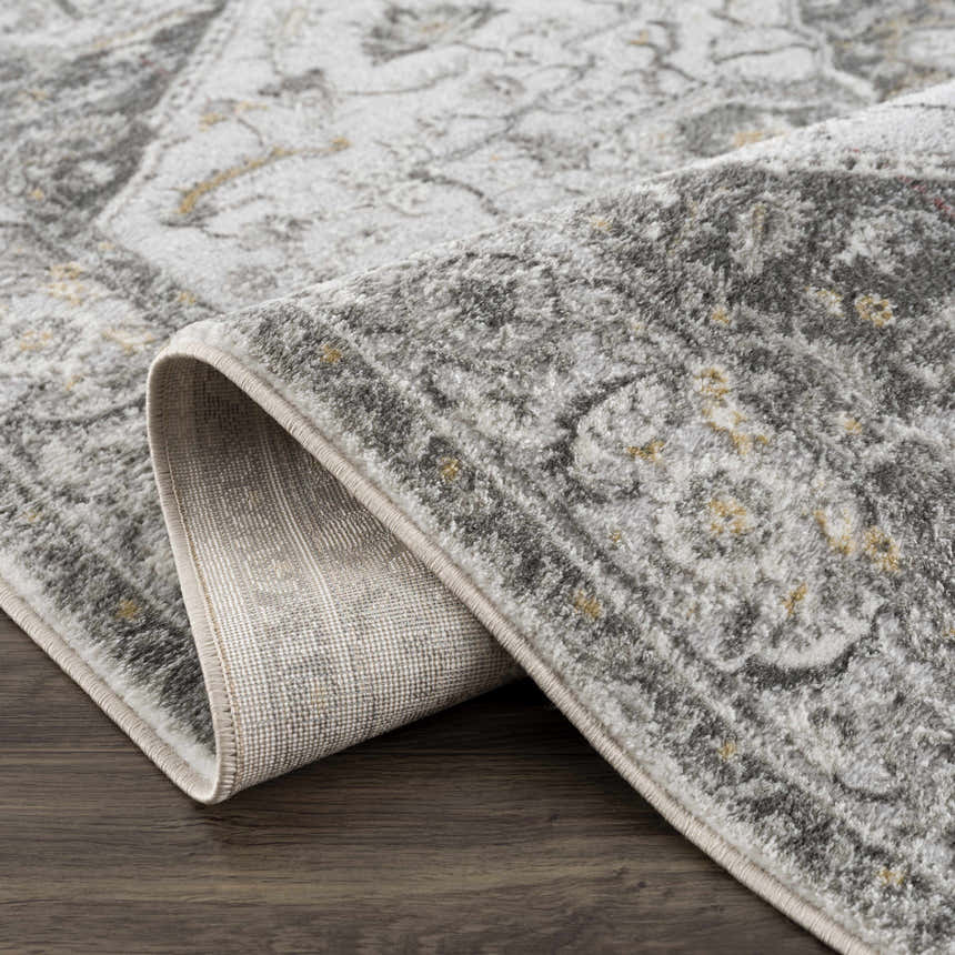 Close-up of the Liverpool Light Gray Area Rug showing the traditional pattern and texture. Charcoal, gray, and mustard tones. Fold