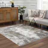 Living room scene with a gray sofa and the Liveree Abstract Area Rug in light gray, medium gray, off white, and rust. Roomscene-Rectangle