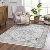 Living room scene with a light gray Liverpool Light Gray Area Rug, chair, and wood cabinet. Roomscene-Rectangle