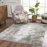 Living room scene with Liveree Abstract Area Rug, light gray chair, wood cabinet, and monstera plant. Roomscene-Rectangle