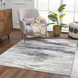 Living room scene with a colorful Liverpool Area Rug, gray armchair, wood cabinet, and monstera plant. Roomscene-Rectangle
