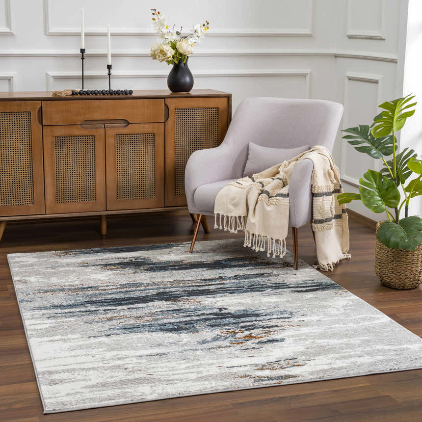 Living room scene with a colorful Liverpool Area Rug, gray armchair, and wood cabinet. Roomscene-Rectangle