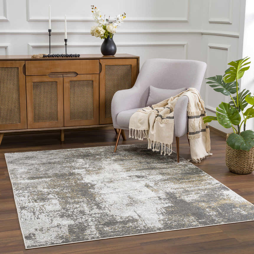 Living room scene with Liveree Abstract Area Rug in light gray, white, and rust, under a chair and wood cabinet. Roomscene-Rectangle