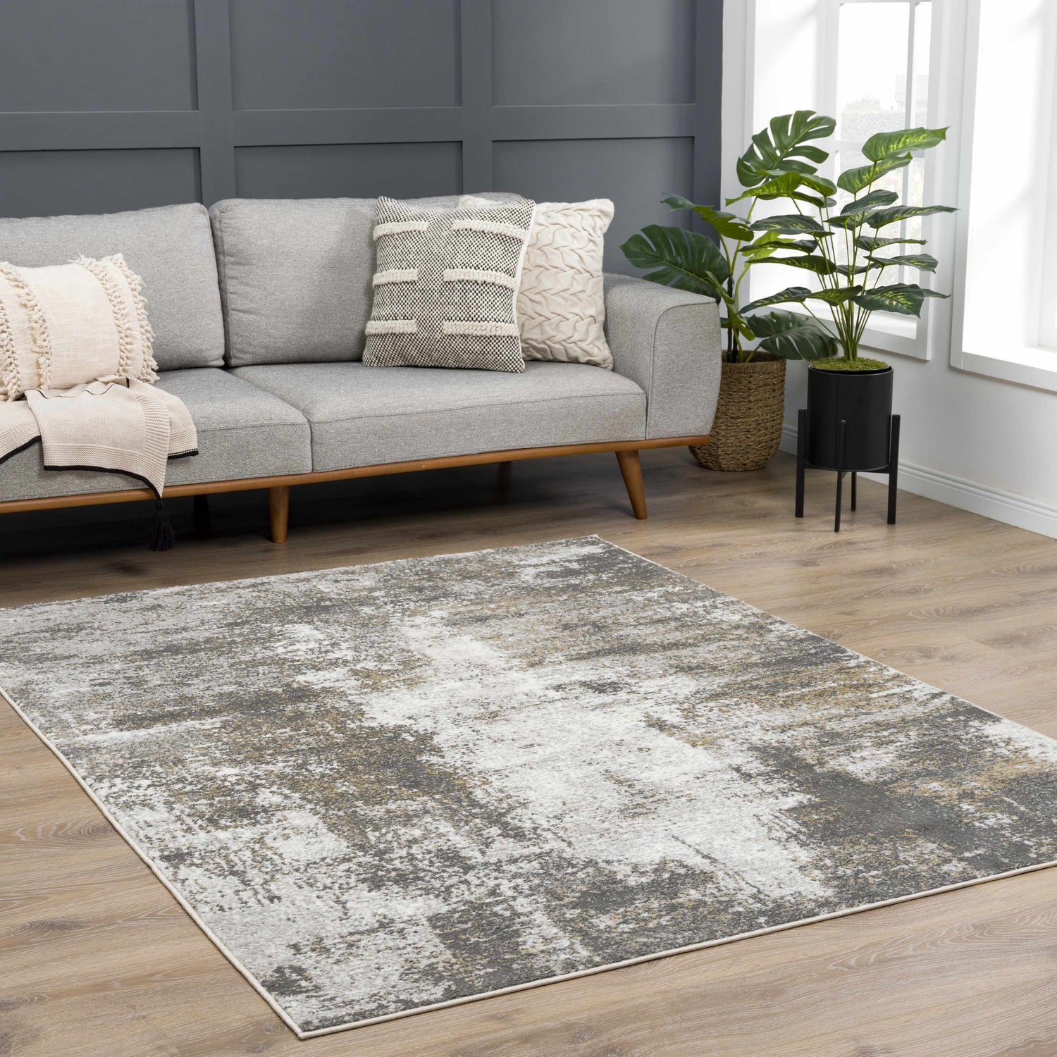 Living room scene with gray sofa and Liveree Abstract Area Rug in light gray, medium gray, off white, and rust. Roomscene-Rectangle