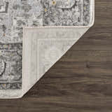Close-up of the Liverpool Light Gray Area Rug showing its traditional pattern, colors, and machine-woven construction. Fold