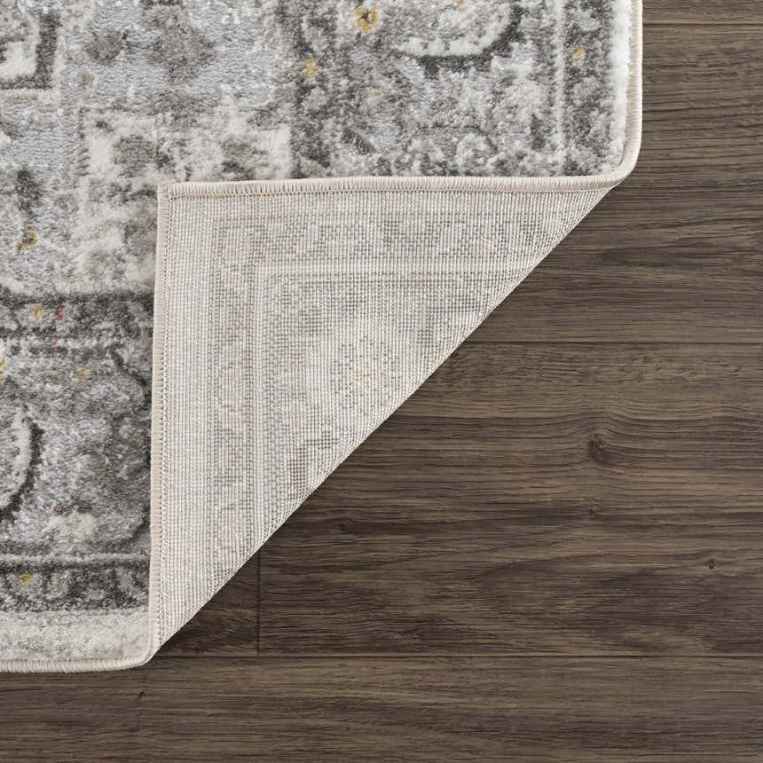 Close-up of the Liverpool Light Gray Area Rug showing its traditional pattern, colors, and machine-woven construction. Fold