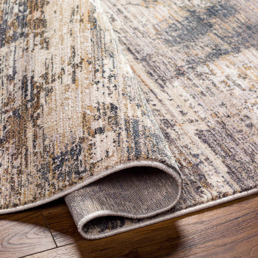 Close-up of the Asuna Area Rug, showcasing its beige, brown, and gray contemporary pattern and soft texture. Fold