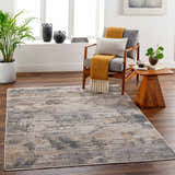 Living room scene with Asuna Area Rug in beige, gray, and brown. Contemporary rug styled with wood chair, side table, and plants. Roomscene-Rectangle