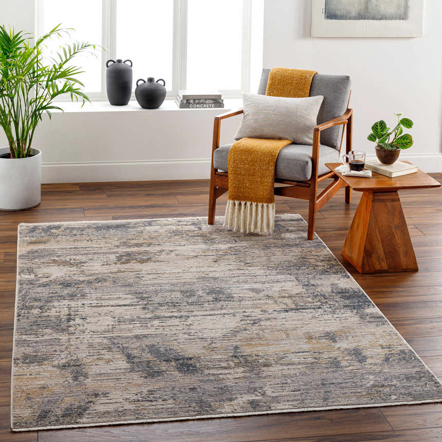 Living room scene with Asuna Area Rug in beige, gray, and brown. Contemporary rug styled with wood chair, side table, and plants. Roomscene-Rectangle