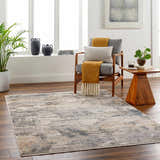 Living room scene with the Asuna Area Rug in beige, gray, and brown tones, styled with a modern chair and wood accents. Roomscene-Rectangle