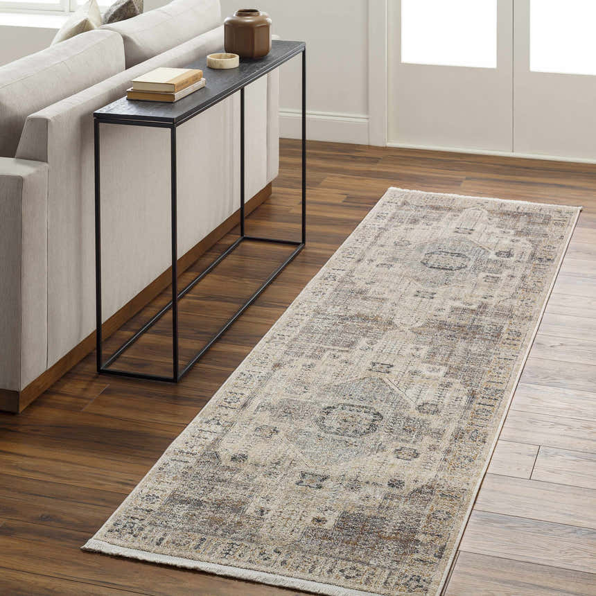 Living room scene with a taupe sofa and the brown and gray Iiona Area Rug runner on hardwood floors. Roomscene-Runner