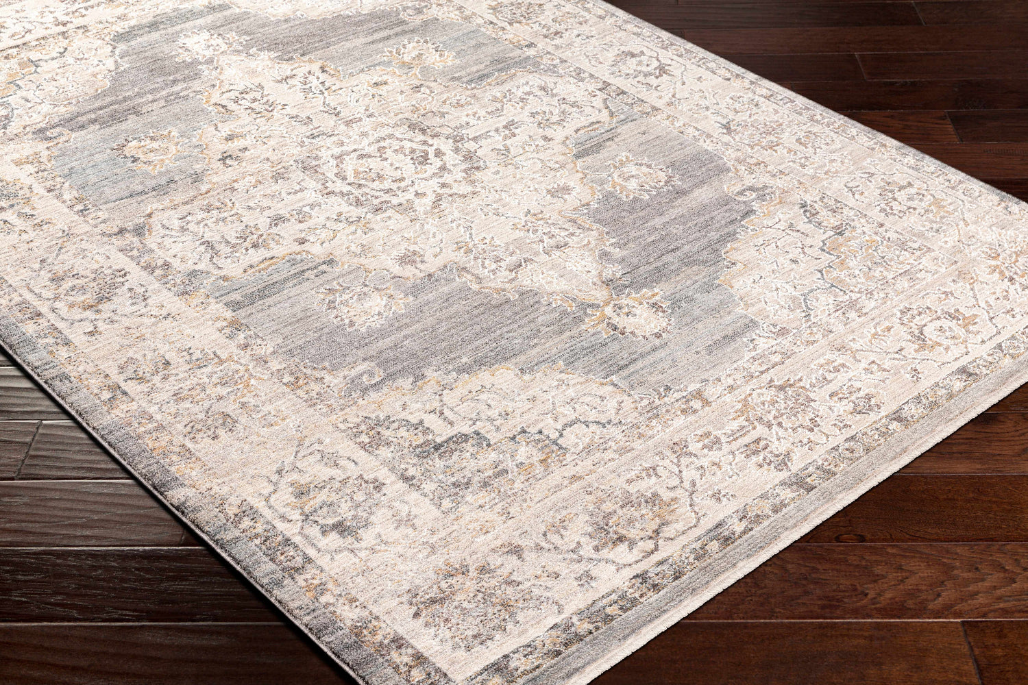 Close-up of the Crea Gray Zola Area Rug showing its traditional floral pattern and soft charcoal, gray, and ivory colors. Corner