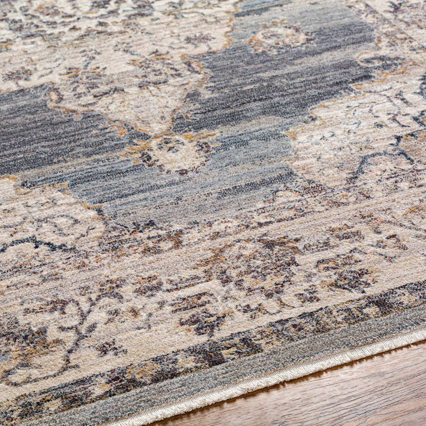 Close-up of the Crea Gray Zola Area Rug showing its traditional pattern, gray, ivory, and tan colors, and soft texture. Texture