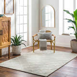 Bright living room with wood floors and Botiu Blue Geometric rug. Cabinet, chair, mirror, and plants complete the scene. Roomscene-Rectangle