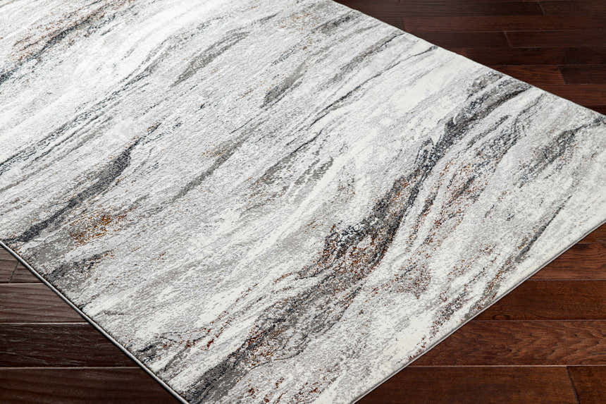 Close-up of Glain Gray & Brown Marble Area Rug showing its abstract, striated pattern and neutral tones on dark wood floor. Corner