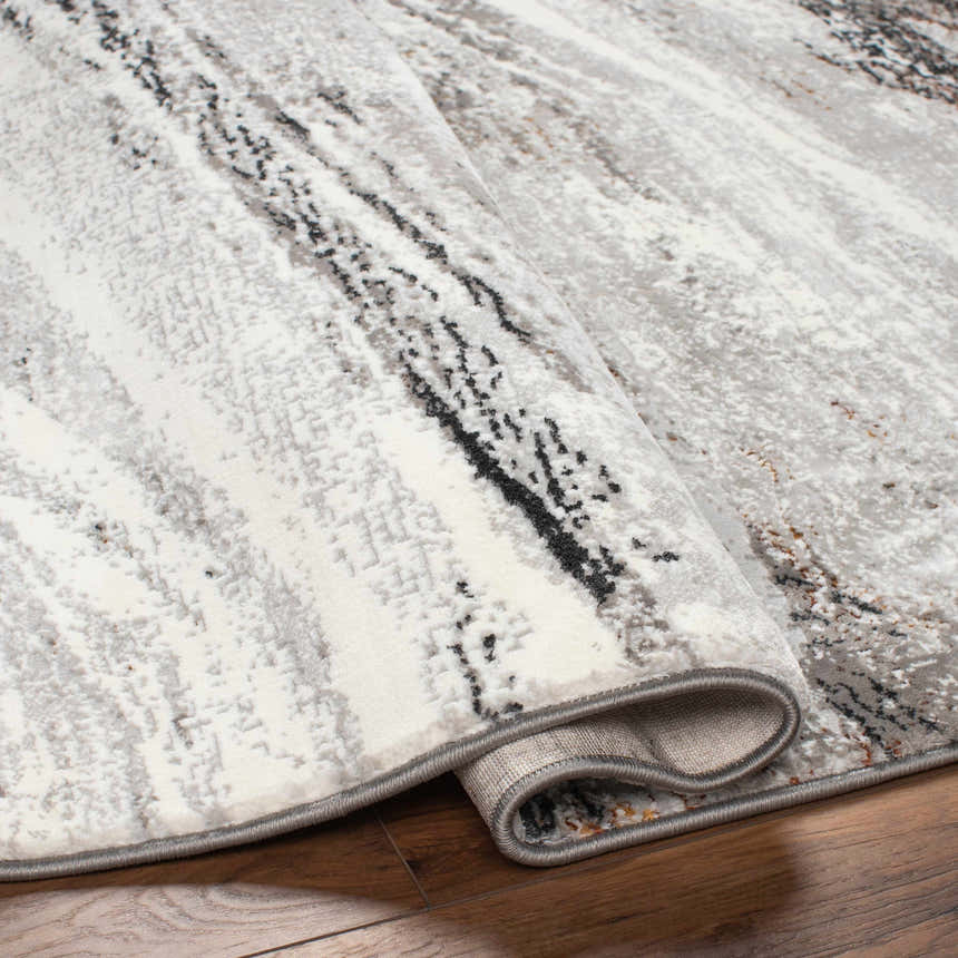 Close-up of the Glain Gray & Brown Marble Area Rug showing its gray, white, and brown marble-like design and jute texture. Fold