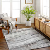 Living room scene with Glain Gray & Brown Marble Area Rug, gray chair, wood console, and indoor plant. Neutral, modern style. Roomscene-Rectangle