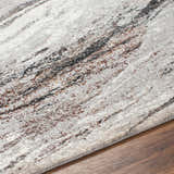 Close-up of the Glain Gray & Brown Marble Area Rug showing the gray, brown, and white marble-inspired pattern and jute texture. Texture