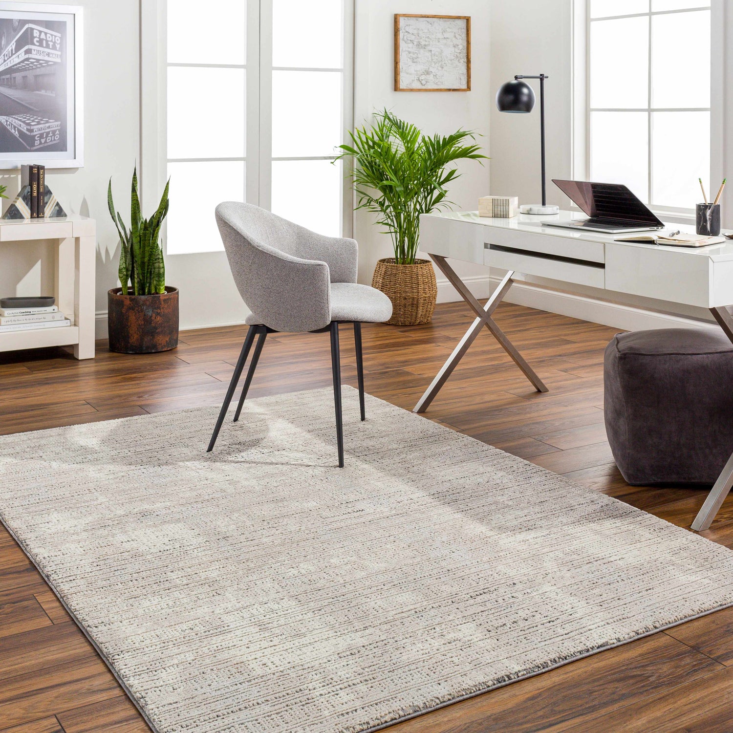 Bright home office with a Chiyo Tan Plush Textured Washable Rug, white desk, gray chair, and wood floors. Roomscene-Rectangle