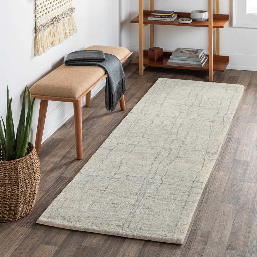 Entryway scene with Saldanha Premium Rug runner in gray, wood floors, bench, and shelf with books. Roomscene-Runner