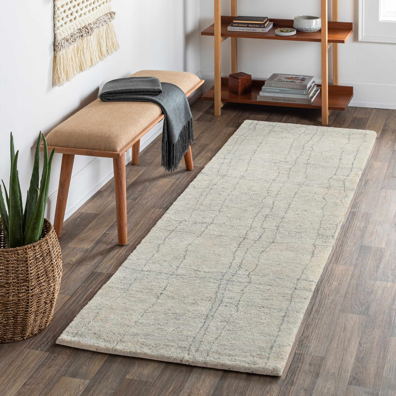 Entryway scene with Saldanha Premium Rug runner in gray, wood floors, bench, and shelf with books. Roomscene-Runner